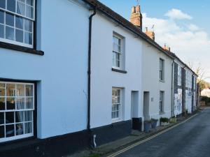 a row of white houses on a street at Sea Breeze in Blakeney