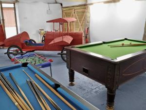 a room with several pool tables and a red carriage at Kettles On - Tkc in Tresmeer