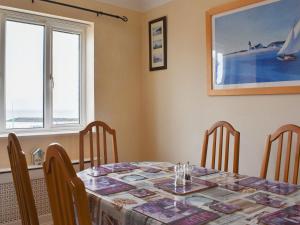 a dining room with a table and chairs at Bay View in Clacton-on-Sea