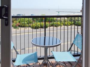 a balcony with a table and two chairs at Bay View in Clacton-on-Sea