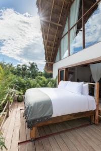 a bedroom with a bed on a deck at La Valise Tulum in Tulum