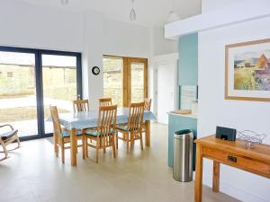 a kitchen and dining room with a table and chairs at The Hayloft - Nab in Aynho