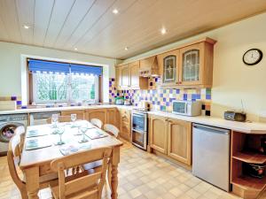 a kitchen with a table and chairs in it at The Cottage in Girvan