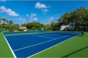 a tennis court with two tennis nets on it at Naples Dream at WTC with Heated Pool SPA Sauna 7 bicycles and 3 mls to beach in Naples