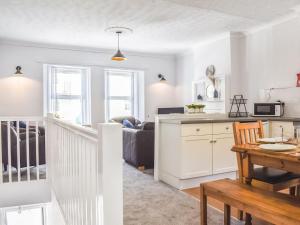 a kitchen and living room with a table and a dining room at Church View in Lynmouth