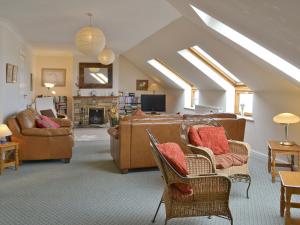 a living room with a couch and chairs in a room at Tamar View in Saltash