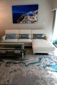a living room with a white couch and a table at Naples Dream at WTC with Heated Pool SPA Sauna 7 bicycles and 3 mls to beach in Naples