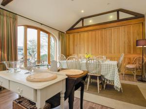 a dining room with a table and chairs at The Stables At Weedon Hill Farm in Church Stowe