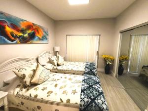 a bedroom with two beds and a painting on the wall at Naples Dream at WTC with Heated Pool SPA Sauna 7 bicycles and 3 mls to beach in Naples