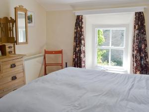 a bedroom with a bed and a window at Belle Vue-ukc778 in Eggleston