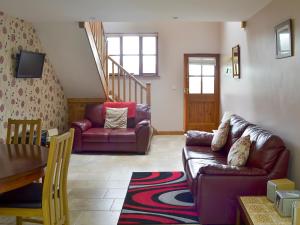 a living room with a couch and a table at Clougha View - 29531 in Scotforth