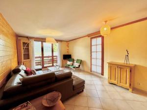 a living room with a couch and a table at Appartement spacieux 8 pers, village, parking, fibre - FR-1-505-183 in Notre-Dame-de-Bellecombe