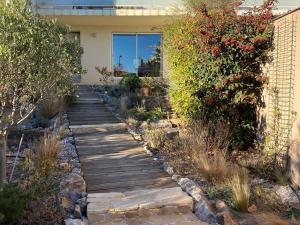 a garden with a wooden walkway in a yard at Villa Leucate, 4 pièces, 7 personnes - FR-1-81-578 in Leucate