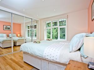 a bedroom with a large bed and windows at Oldway Apartment in Paignton