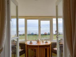 a room with a table in front of a window at Felix Court in Felixstowe