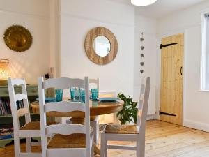 a dining room with a table and chairs at Turnstone in Bideford