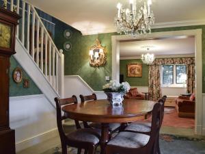 a dining room with a table and chairs at The Coach House in Great Easton