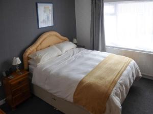 a bedroom with a large bed with a large window at The Briar Rose in New Herrington
