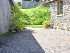 a shadow of a building next to a driveway at The Byre in Morland