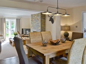 a living room with a wooden table and chairs at Willow Tree Cottage in Foxholes