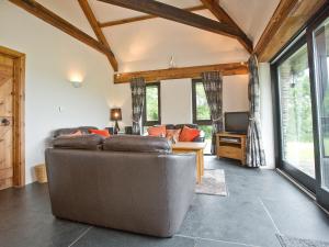 a living room with a couch and a desk at The Linhay in Little Petherick