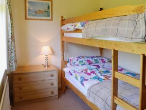 a bedroom with a bunk bed and a night stand at Far Horizons in Seaview