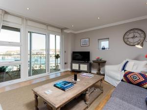 a living room with a couch and a table at 16 Marinus in Cowes