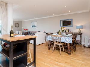 a dining room and living room with a table and chairs at 16 Marinus in Cowes