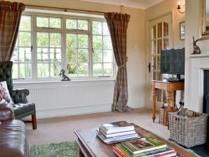 a living room with a couch and a window at Tickton Hall Cottage in Tickton