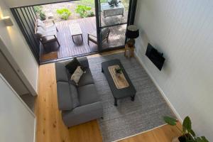 an overhead view of a living room with a couch and a table at Hilltop Woods Noosa in Tinbeerwah