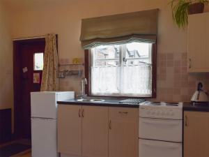 a kitchen with a sink and a window at The Dairy in Burscough