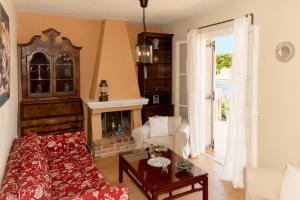 a living room with a couch and a fireplace at Captain's Quarters at Fiscardo Waterfront-feel the breeze in Fiskardho