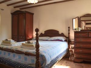 a bedroom with a wooden bed with a wooden dresser at The Cider Press in Welland