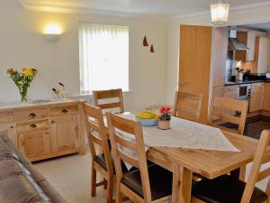 a kitchen and dining room with a table and chairs at Summer Moon in Delabole