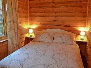 a bedroom with a bed in a wooden wall at Moorside Lodge in Soutergate