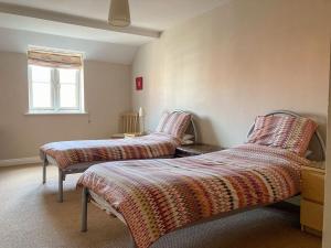 a bedroom with two beds and a window at River Side in Whitby