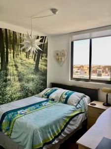 a bedroom with a bed and a large window at Best View of Pimentel in Pimentel