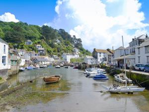 a river with boats docked in a small town at Watersmeet in Looe