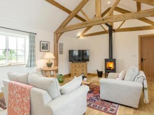 a living room with white furniture and a fireplace at The Old Dairy-ukc2112 in Royal Wootton Bassett