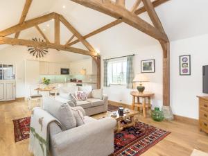 a living room with a couch and a table at The Old Dairy-ukc2112 in Royal Wootton Bassett