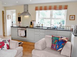 a kitchen with two chairs and a kitchen counter at Heathfield in Denholm