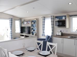 a kitchen and dining room with a table and chairs at The Retreat in Budleigh Salterton
