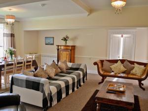 a living room with a couch and a table at The Old Barn - 28971 in Selstead