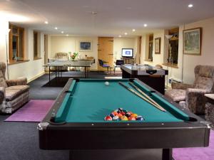 a living room with a pool table and two tables at The Old Barn - 28971 in Selstead