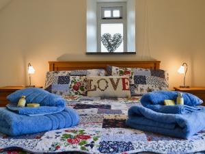 Un dormitorio con una cama con almohadas azules. en Y Cartws, en Sarnau