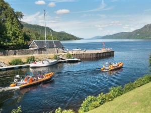 a group of boats in a body of water at Ardgay in Fort Augustus