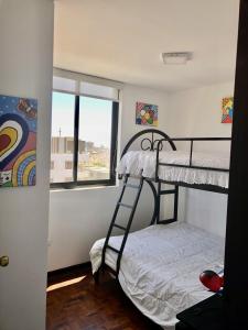 a bedroom with two bunk beds and a window at Best View of Pimentel in Pimentel