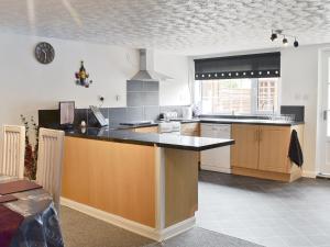 a kitchen with a large island in the middle at Banovallum Cottage in Horncastle