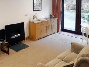 a living room with a couch and a fireplace at Jebel Kasr in Braithwaite