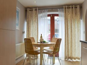 a table and chairs in a kitchen with a window at Lavender Cottage was Fellside in Melmerby